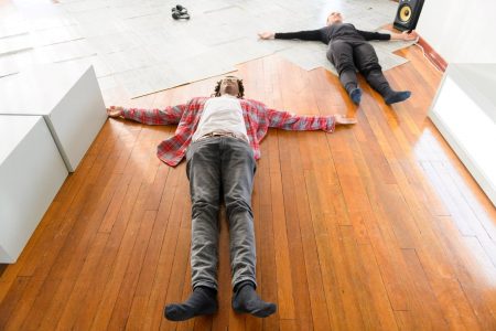 A man and a dancer lie spreadeagled on the floor in the same position, in Katja Heitmann’s Motus Mori